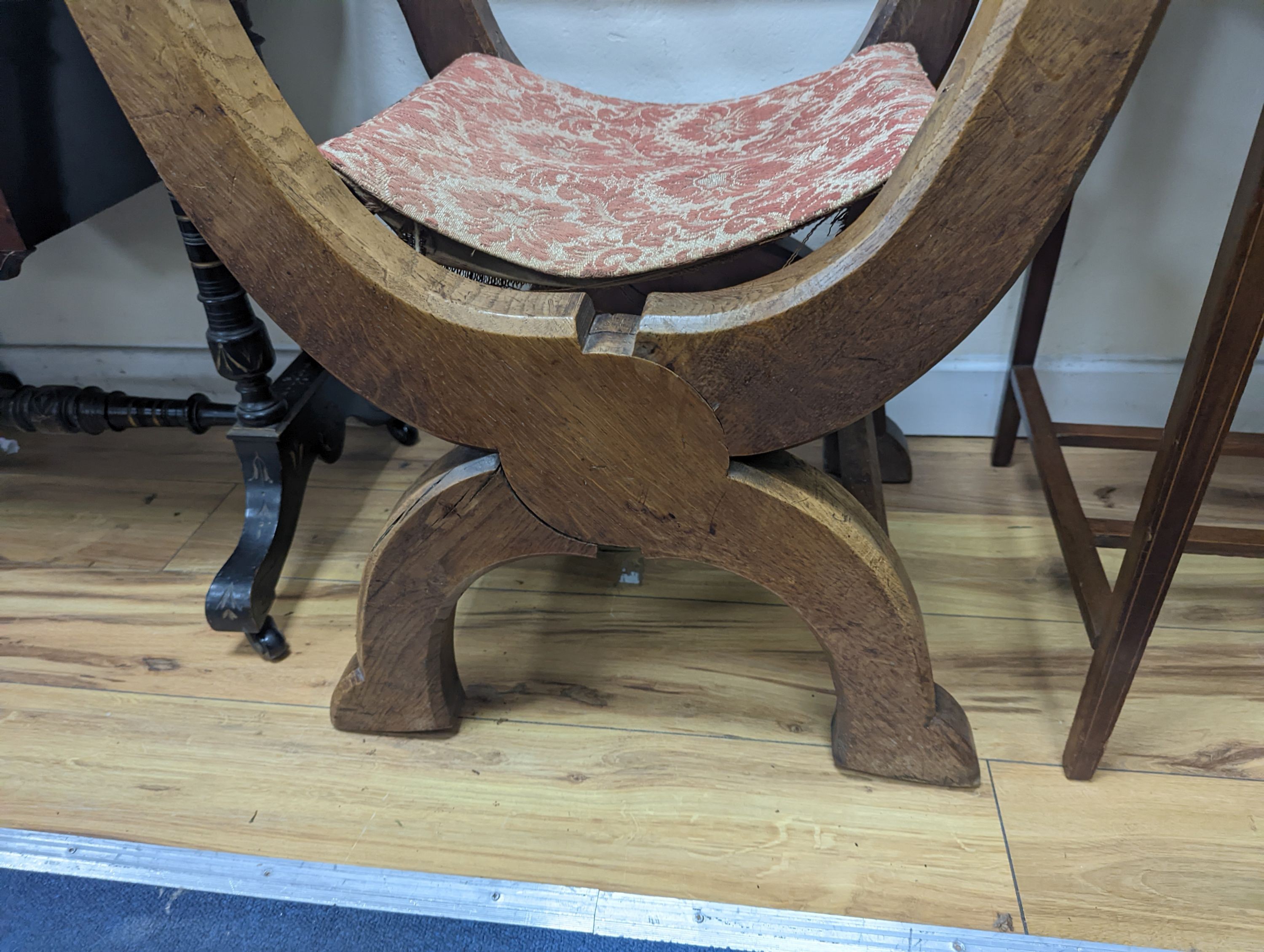 A brass mounted oak folding X framed elbow chair, width 58cm, depth 47cm, height 90cm